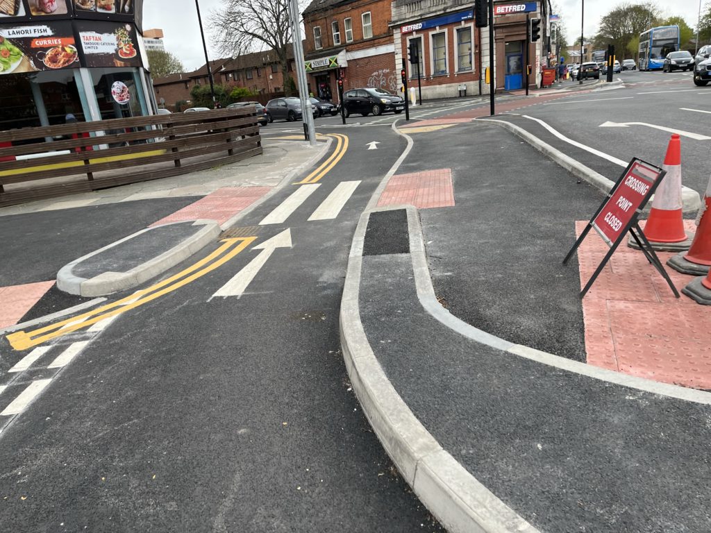 Preparing to cross over a zebra crossing without Belisha Beacons on a CYCLOPS junction